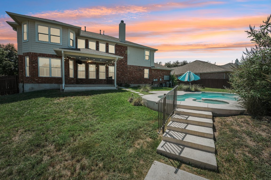 12421 Gun Metal Drive Austin, TX 78739 - Photo 3 of 40 a front view of a house with a yard