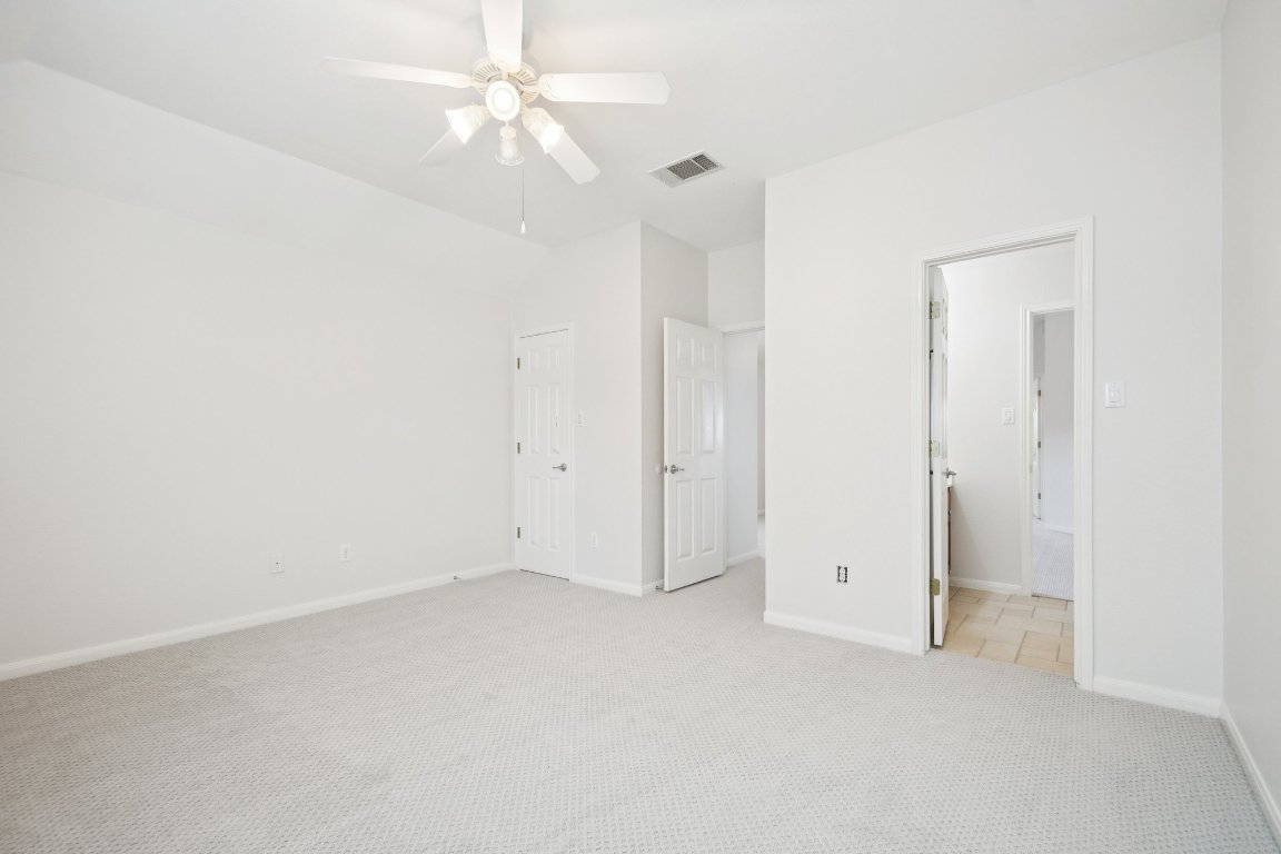 12421 Gun Metal Drive Austin, TX 78739 - Photo 33 of 40 an empty room with a ceiling fan and a window