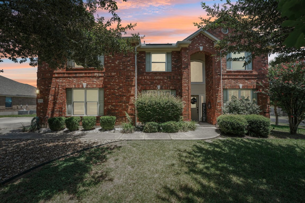 12421 Gun Metal Drive Austin, TX 78739 - Photo 4 of 40 a front view of a house with a yard and garage