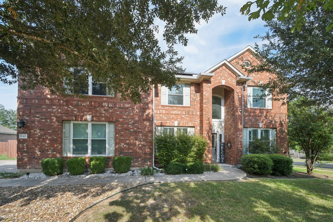 12421 Gun Metal Drive Austin, TX 78739 - Photo 5 of 40 a front view of a house with garden