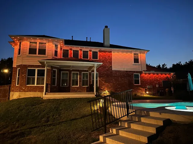 a living room with furniture a fireplace and a large window