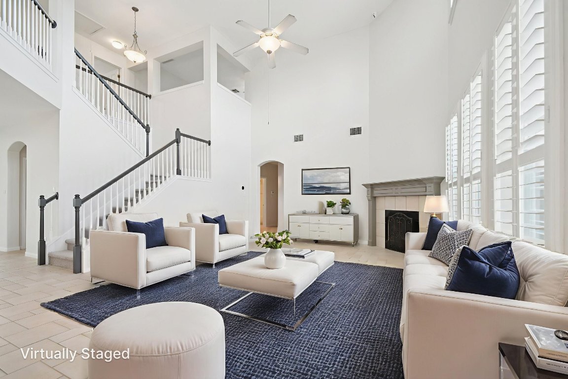 12421 Gun Metal Drive Austin, TX 78739 - Photo 8 of 40 a living room with furniture a fireplace and a large window