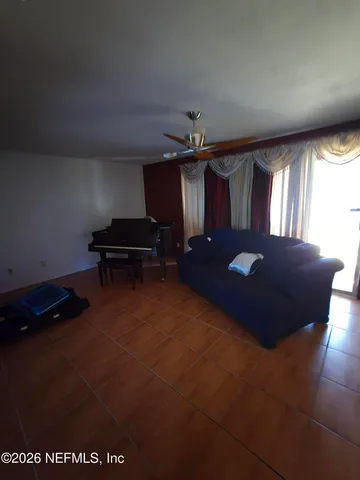 a view of a room with furniture and windows