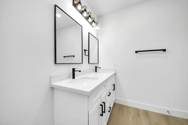 a bathroom with a sink a mirror and a vanity