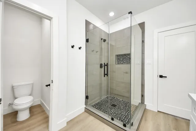 a bathroom with a shower and a toilet
