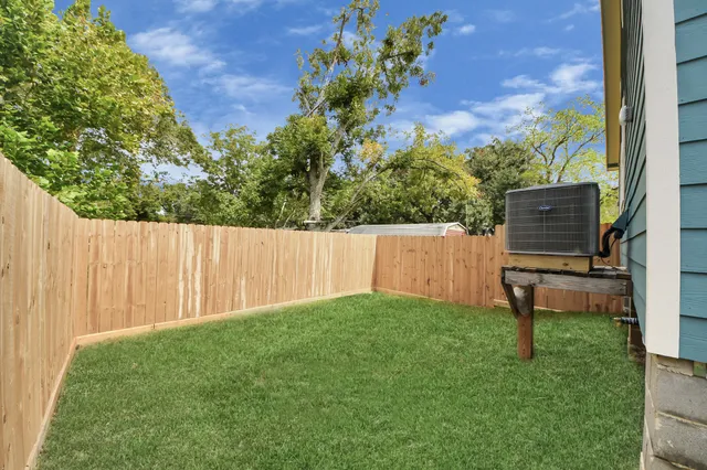 a view of a backyard with wooden fence