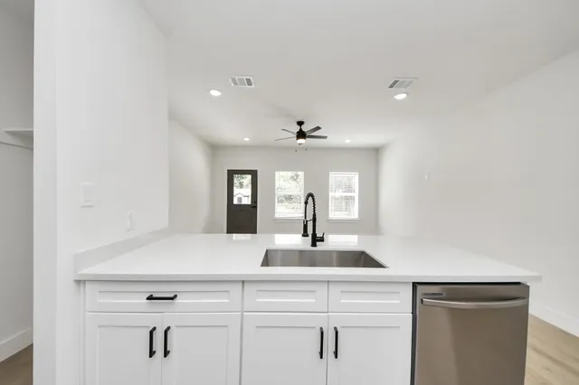a view of living room with granite countertop furniture a window and a potted plant