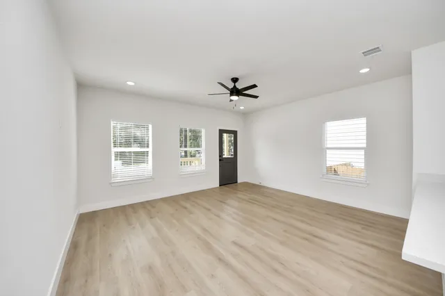 a view of an empty room and a window