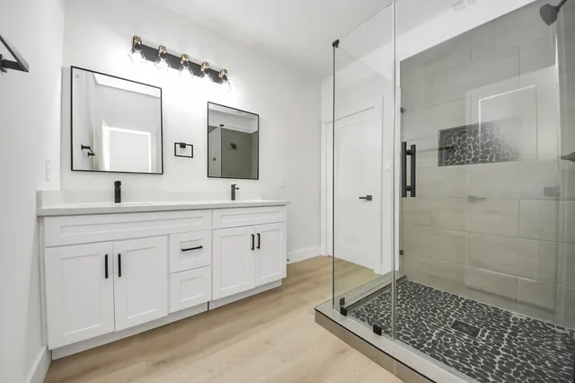 a bathroom with a double vanity sink and mirror