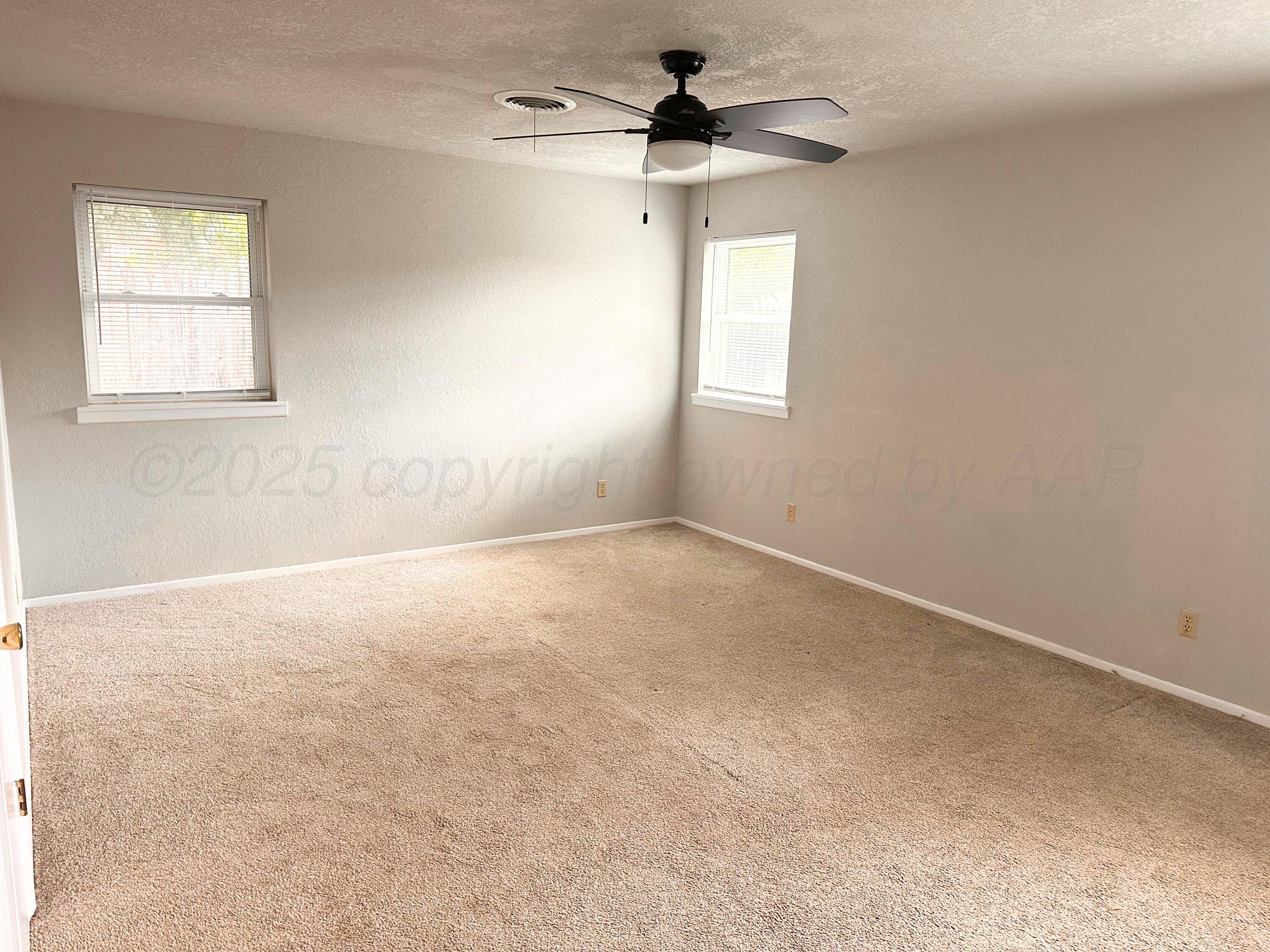 6007 Palmetto Trail Amarillo, TX 79106 - Photo 19 of 23 an empty room with windows and fan