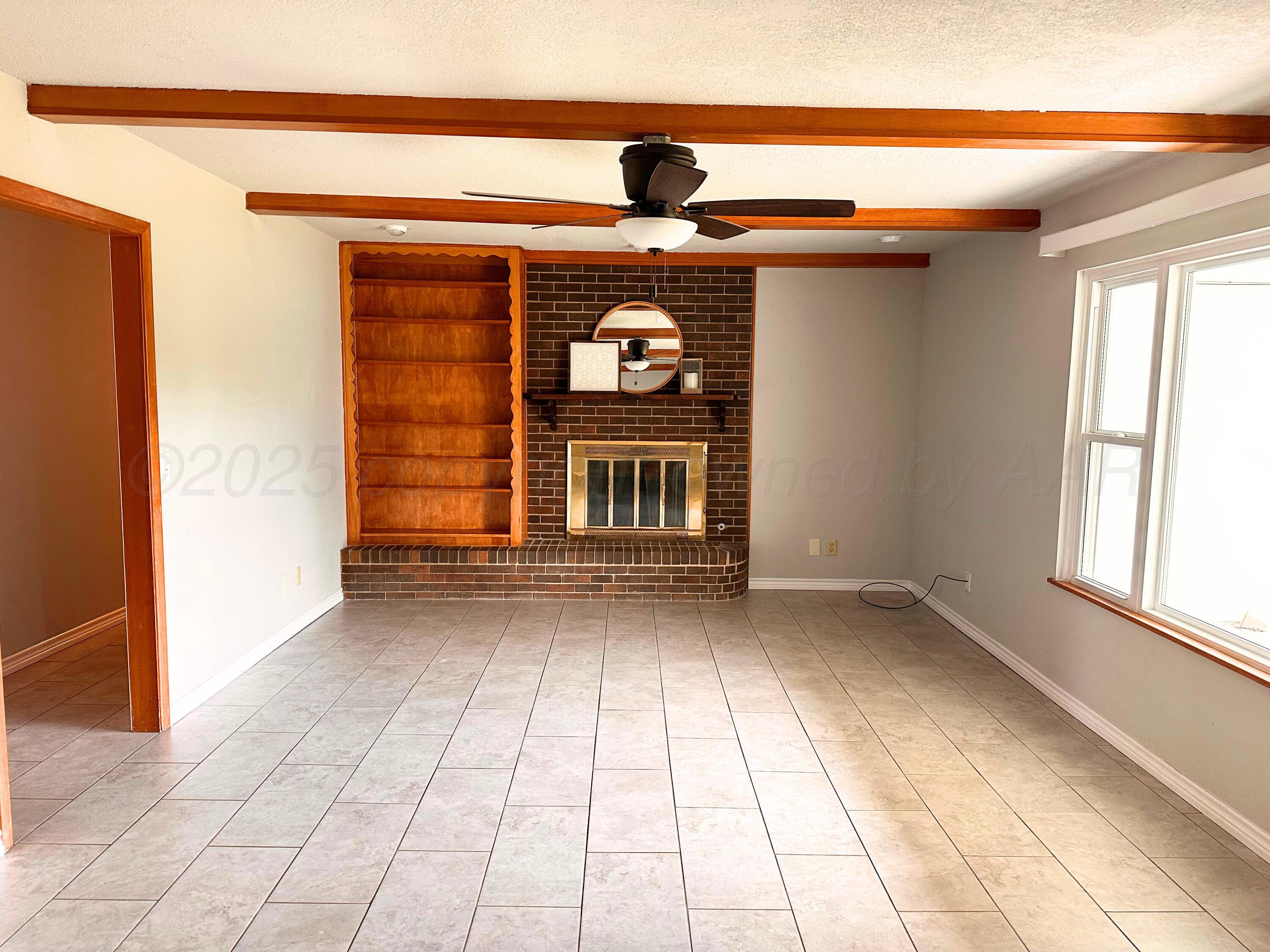 6007 Palmetto Trail Amarillo, TX 79106 - Photo 2 of 23 a view of an empty room with window and cabinet