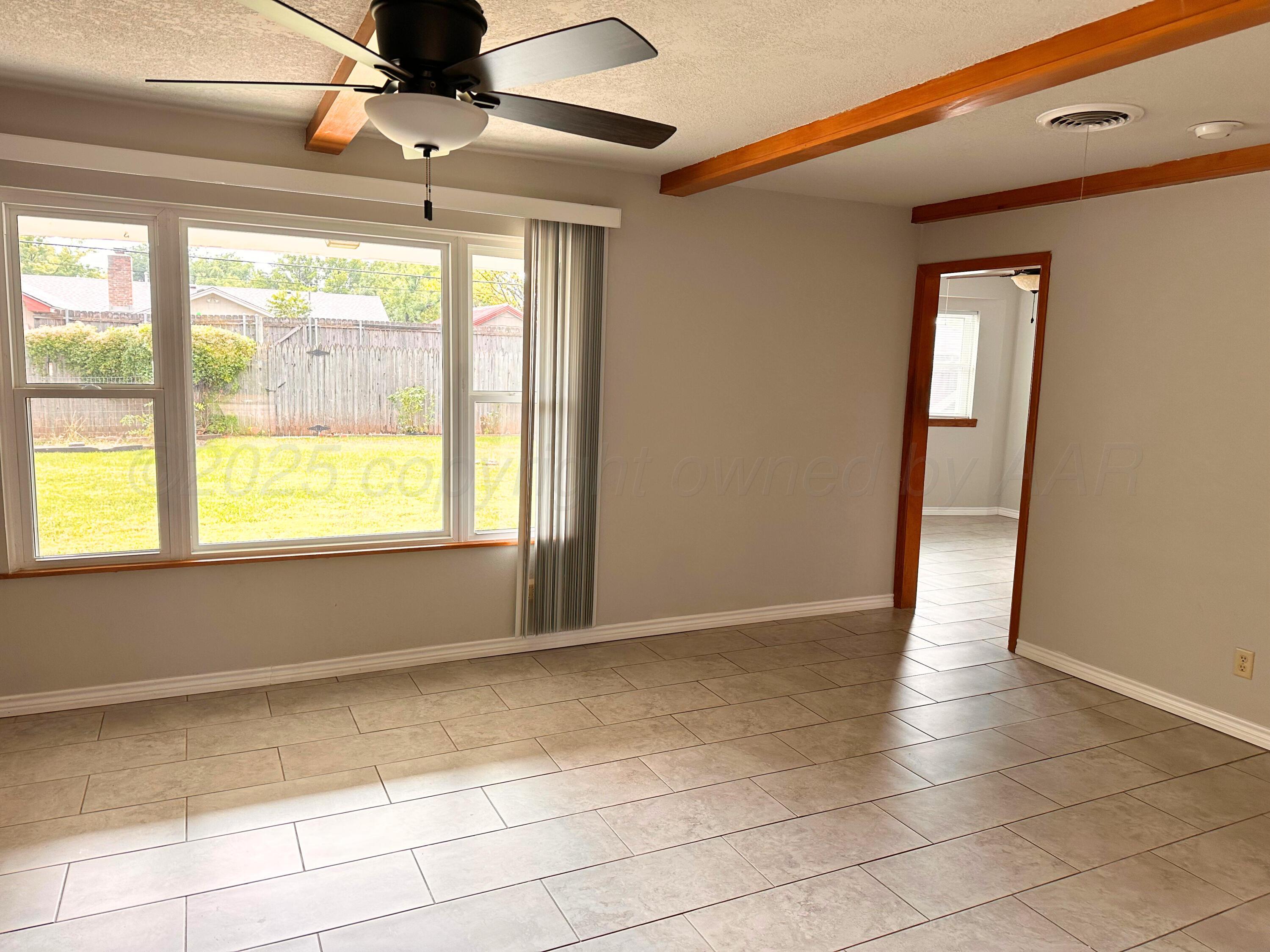 6007 Palmetto Trail Amarillo, TX 79106 - Photo 4 of 23 a view of an empty room with a window