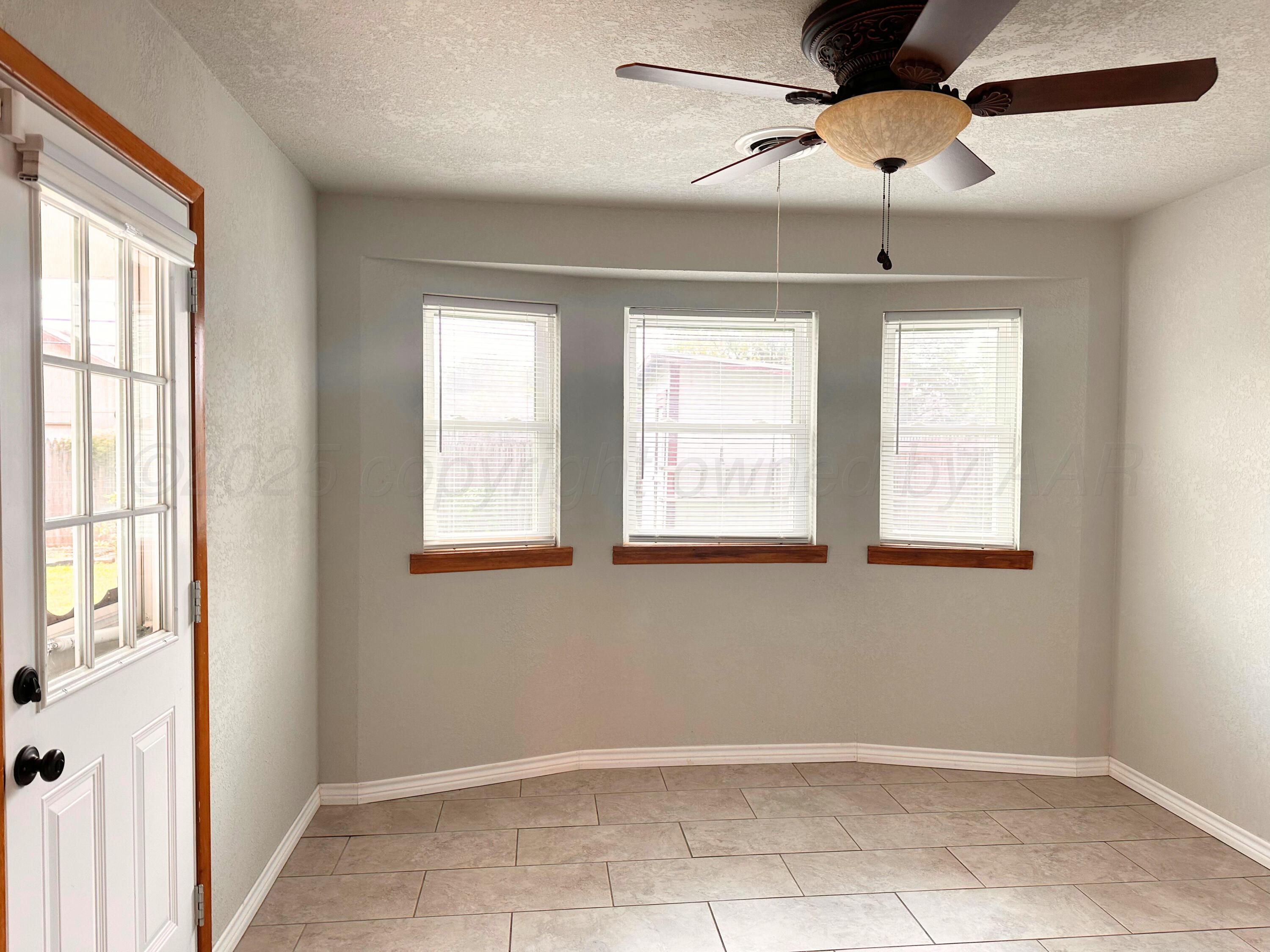 6007 Palmetto Trail Amarillo, TX 79106 - Photo 6 of 23 a view of an empty room with a window