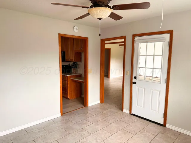 an empty room with closet and windows