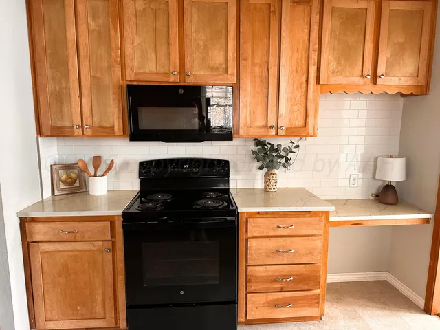 a kitchen with a stove and a microwave