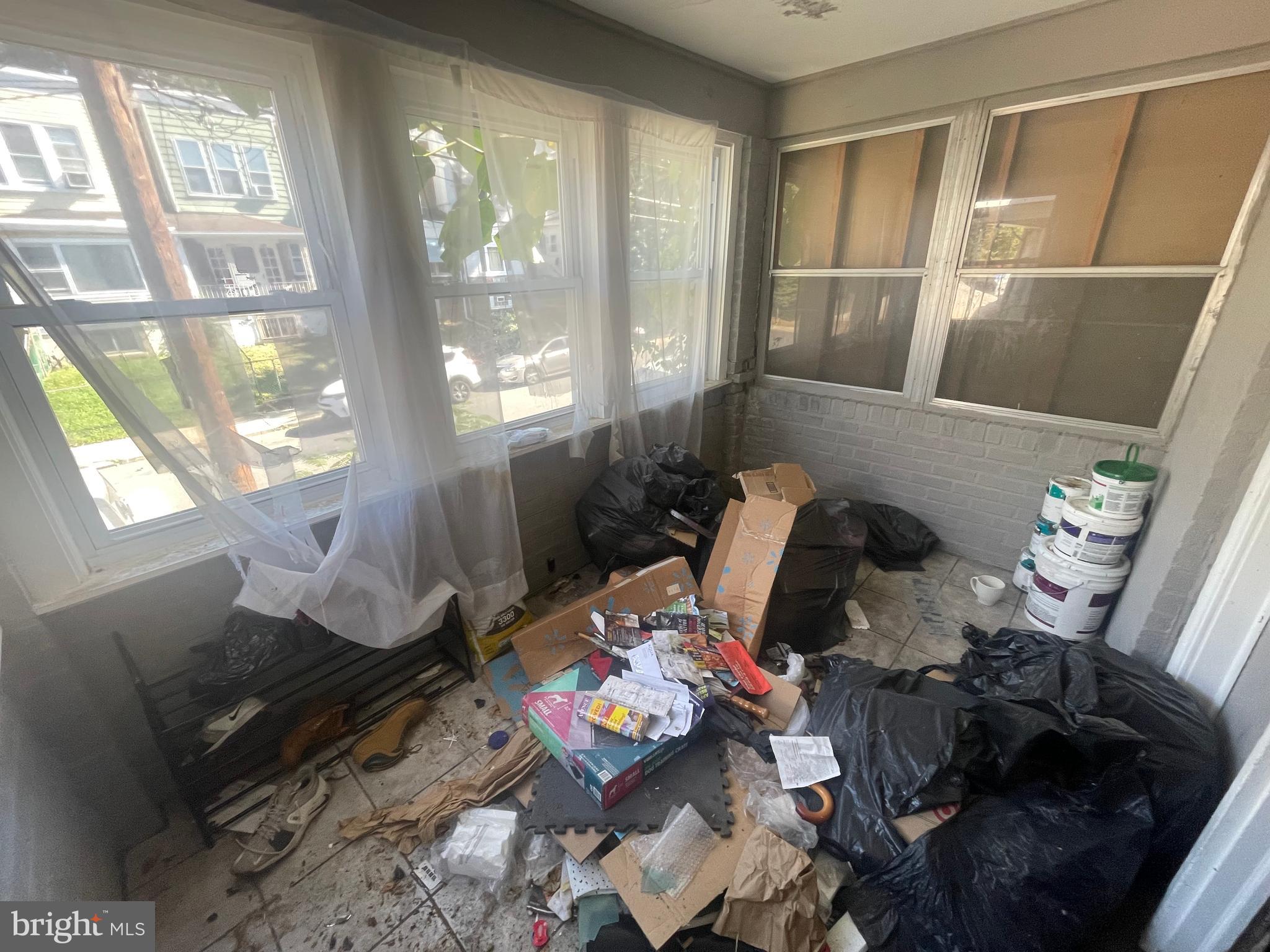 124 North 3rd Street Darby, PA 19023 - Photo 4 of 16 a living room with furniture and a floor to ceiling window