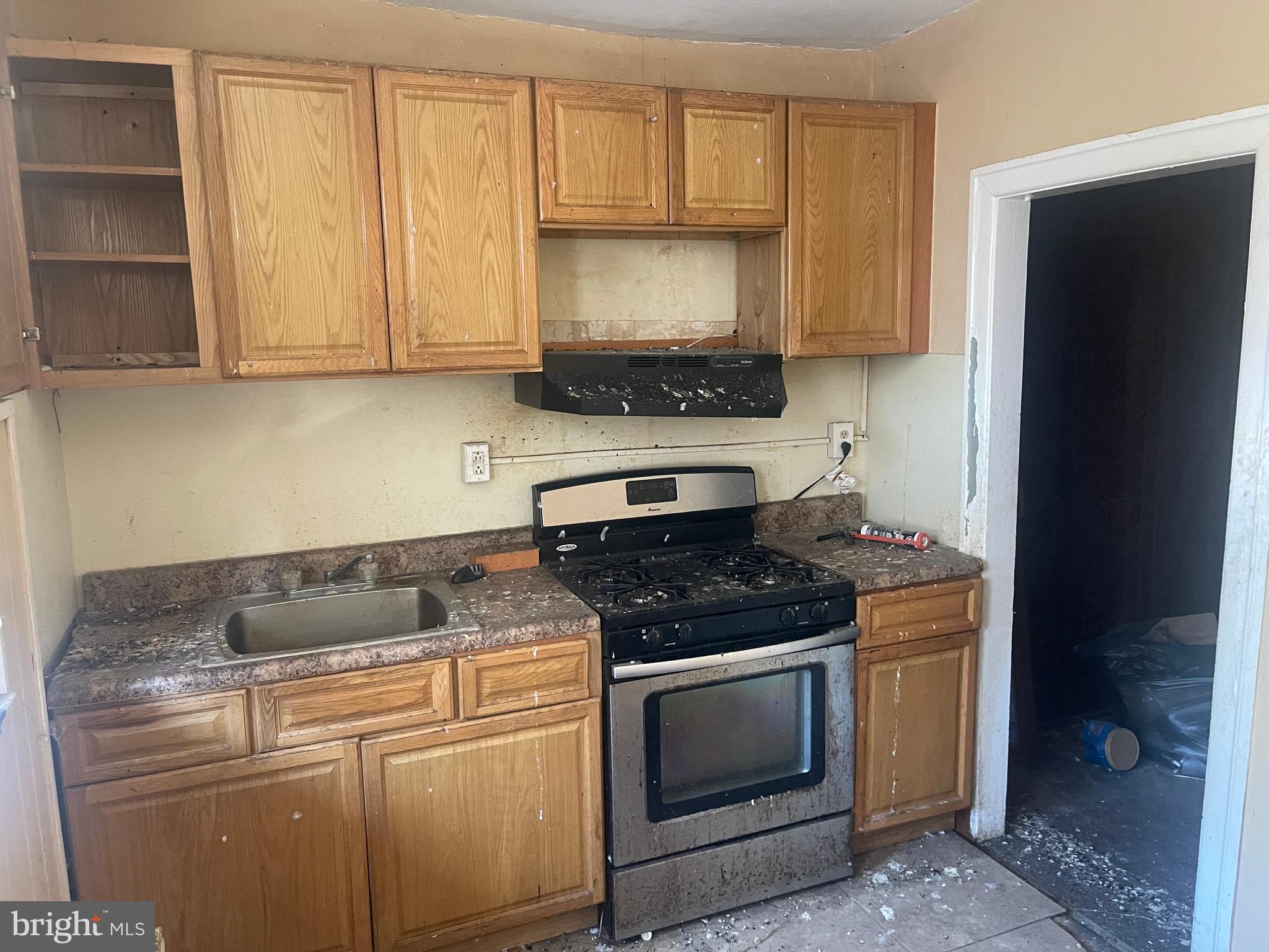 124 North 3rd Street Darby, PA 19023 - Photo 8 of 16 a kitchen with granite countertop white cabinets and stainless steel appliances