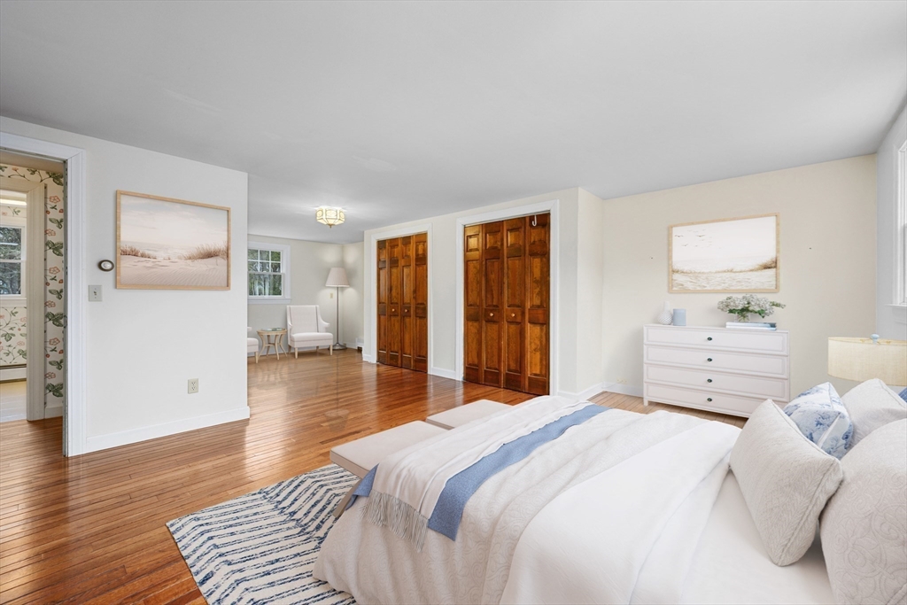 25 Robert Road Harwich, MA 02645 - Photo 19 of 36 a bedroom with a large bed and wooden floor