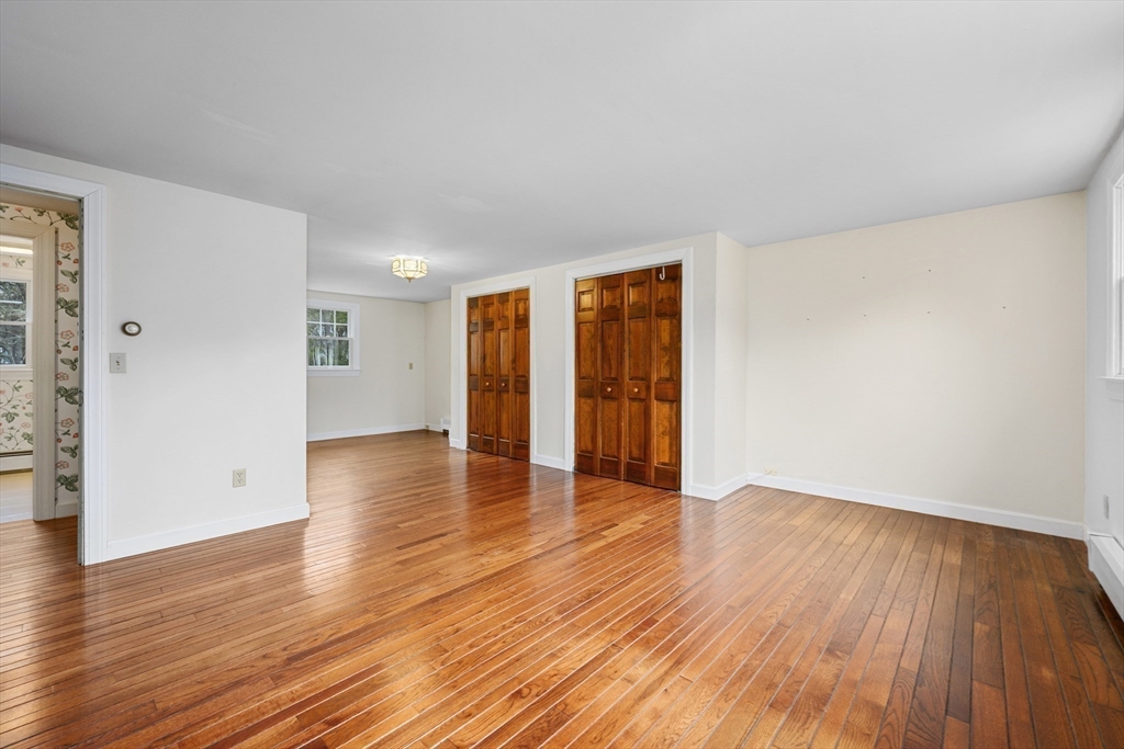 25 Robert Road Harwich, MA 02645 - Photo 20 of 36 a view of an empty room with wooden floor and a window