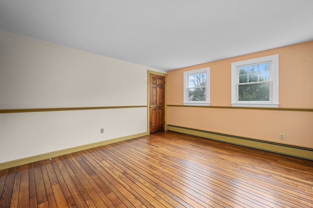 25 Robert Road Harwich, MA 02645 - Photo 23 of 36 an empty room with wooden floor and windows