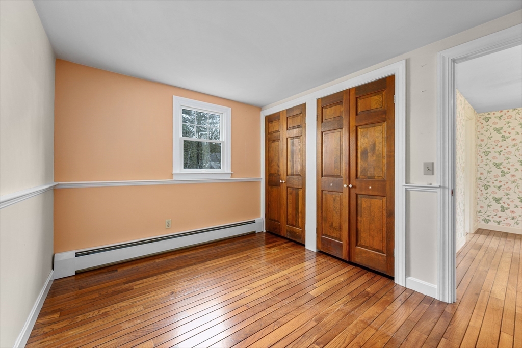 25 Robert Road Harwich, MA 02645 - Photo 25 of 36 an empty room with wooden floor and windows