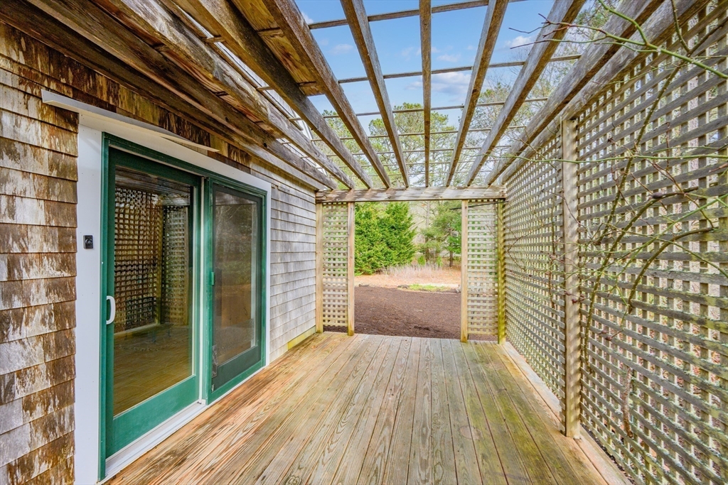 25 Robert Road Harwich, MA 02645 - Photo 33 of 36 a view of a room with wooden floor and iron stairs