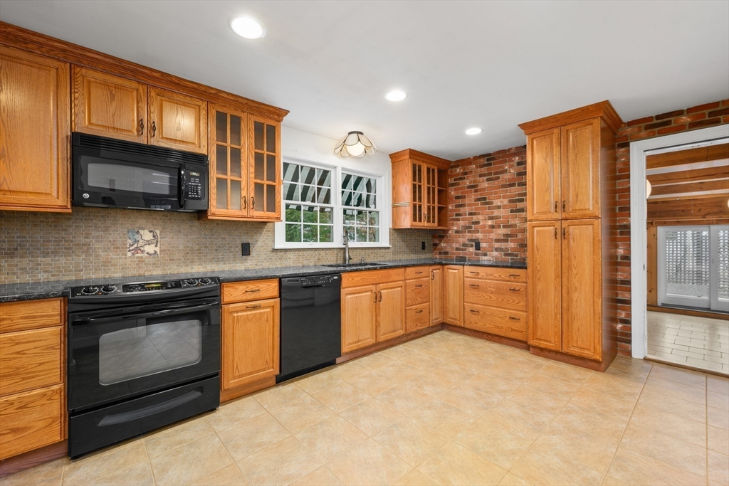 25 Robert Road Harwich, MA 02645 - Photo 8 of 36 a kitchen with stainless steel appliances granite countertop a stove microwave and refrigerator