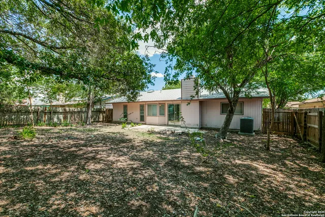 a house that has a tree in front of it
