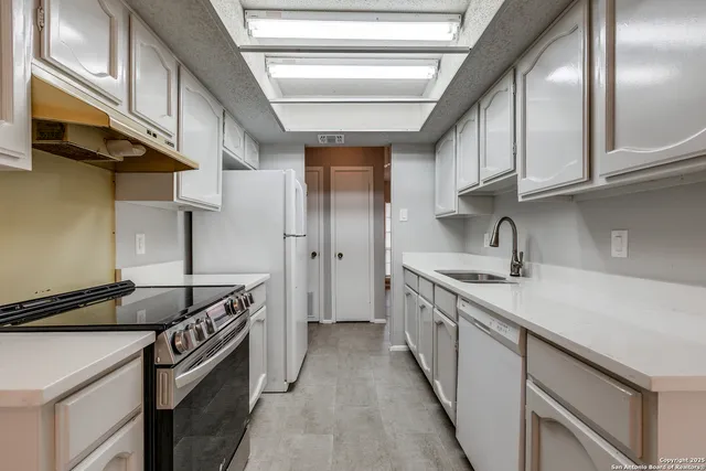 a kitchen with a sink and cabinets