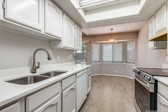 a kitchen with stainless steel appliances a sink and cabinets