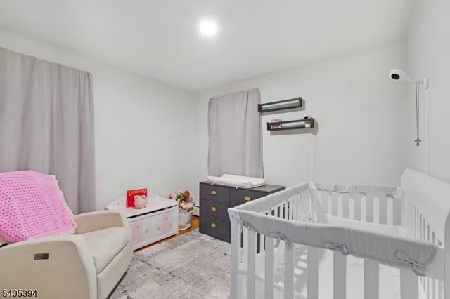 a bedroom with furniture and baby crib
