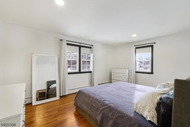 a bedroom with a large bed and a wooden floor