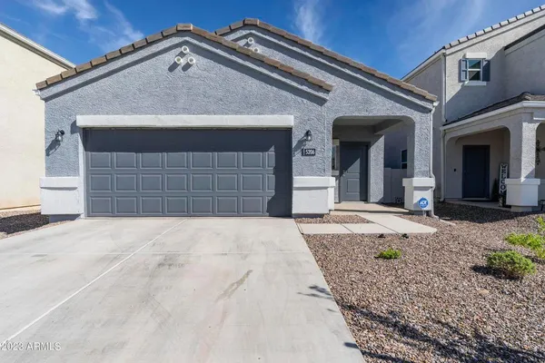 a front view of a house with a yard and garage