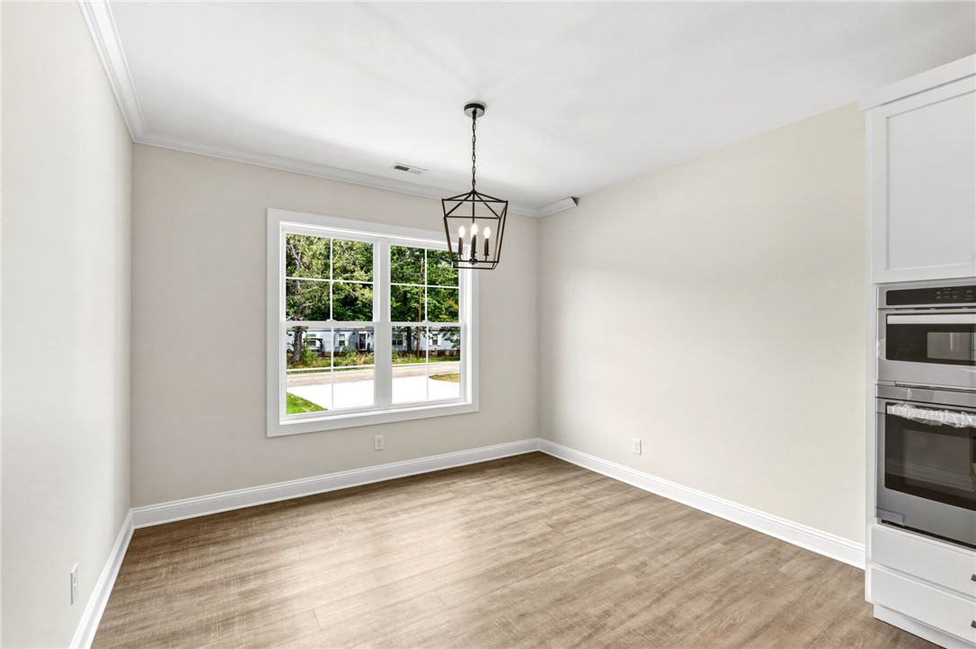 1735 Maw Bridge Road Central, SC 29630 - Photo 15 of 38 This bright dining area features an elegant light fixture and a spacious window overlooking the outdoors.
