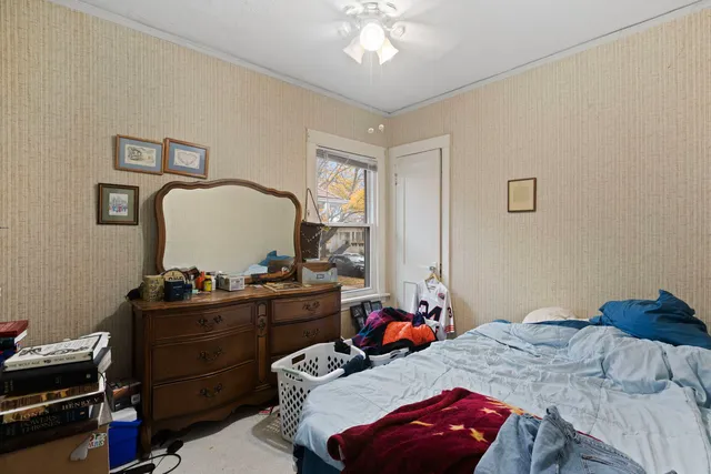 a bedroom with a bed and a chandelier