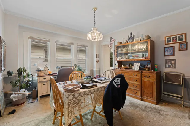 a view of a dining room with furniture and chandelier