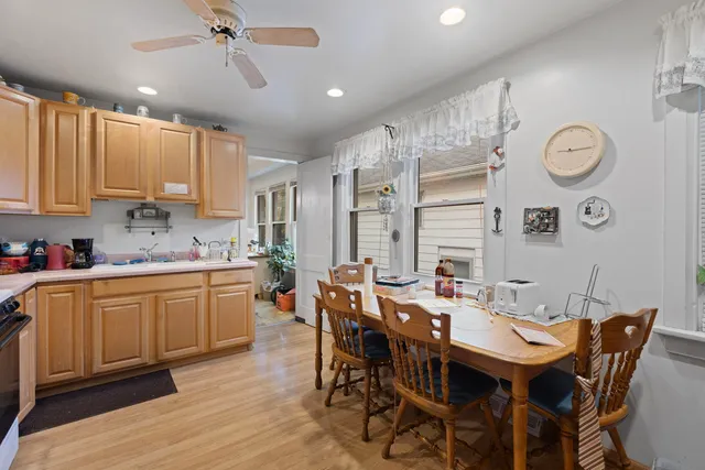 a large kitchen with a table and chairs