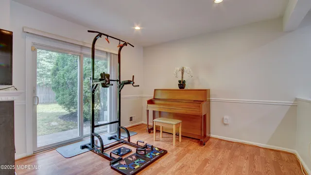 a living room with furniture and a floor to ceiling window