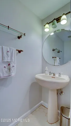 a bathroom with a sink a toilet and mirror