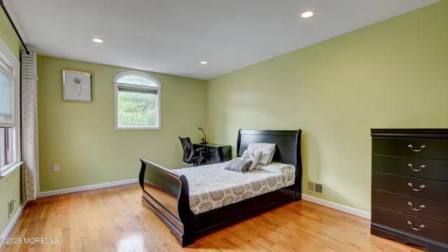 a bedroom with a bed and a night stand