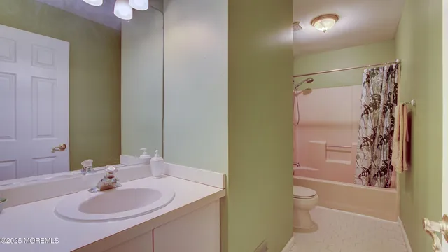a bathroom with a sink toilet tub and shower