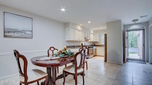 a dining room with furniture and a kitchen view