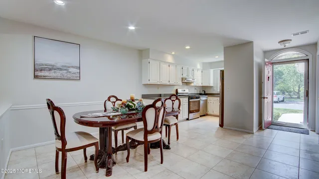 a dining room with furniture and window