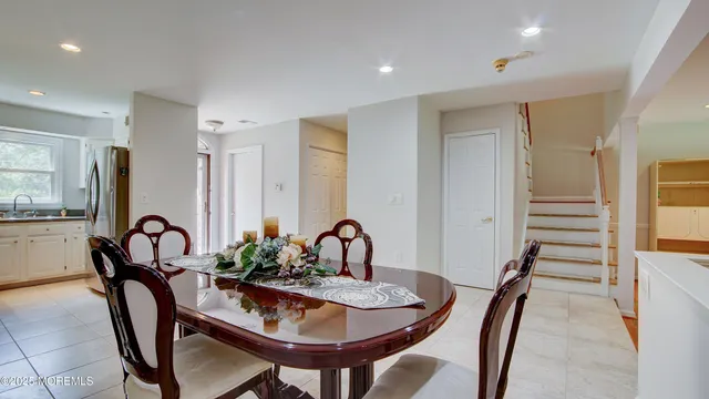 a dining room with furniture and window
