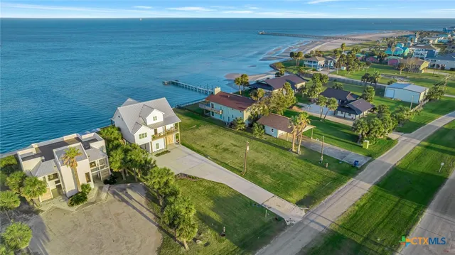 an aerial view of a house with a ocean view