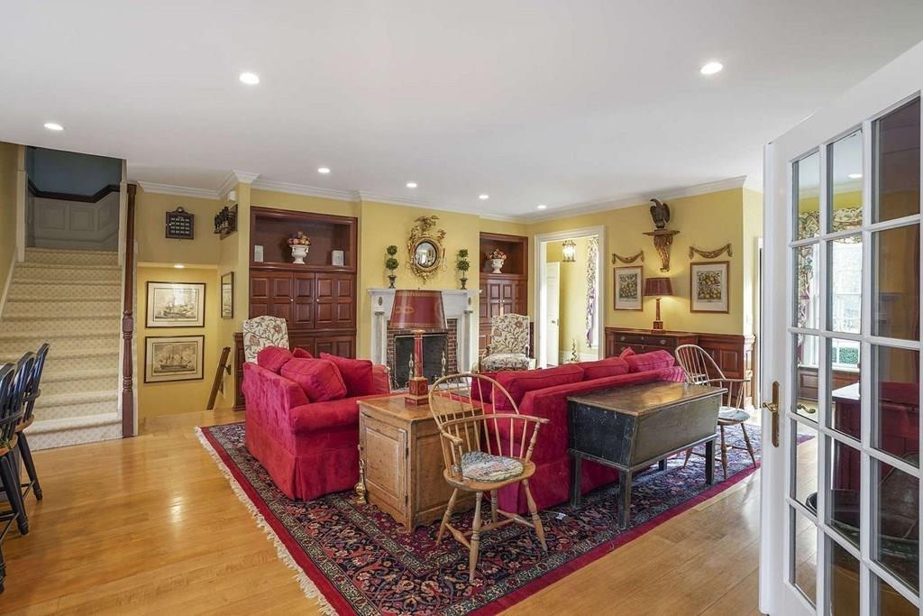 25 Smith Street Dover, MA 02030 - Photo 4 of 39 a living room with furniture a rug and a chandelier