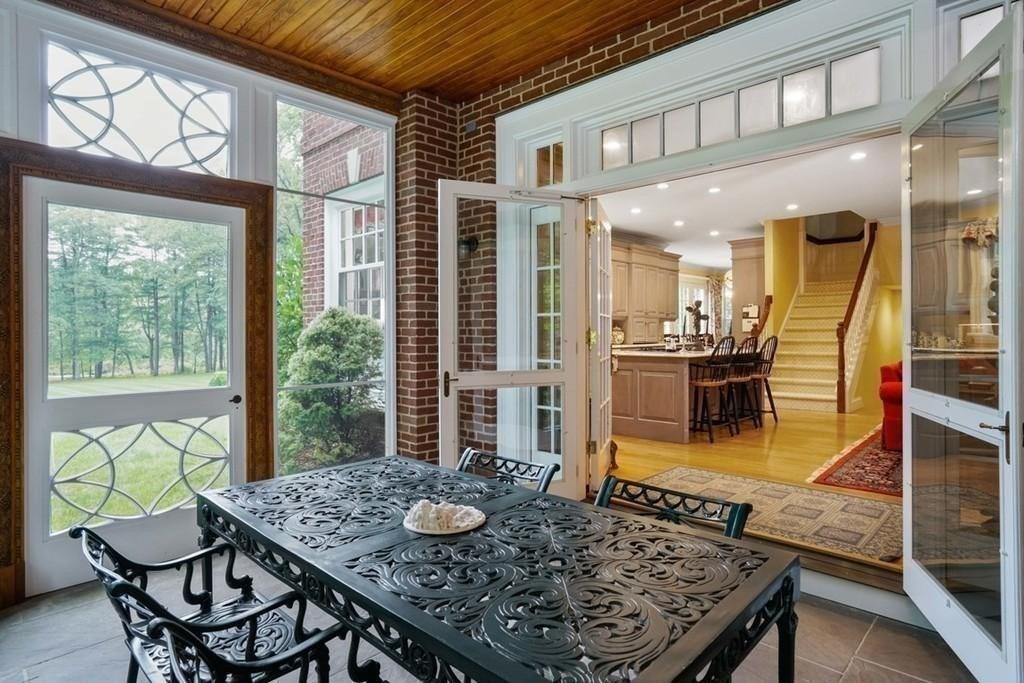 25 Smith Street Dover, MA 02030 - Photo 9 of 39 a view of a dining room with furniture a chandelier and wooden floor