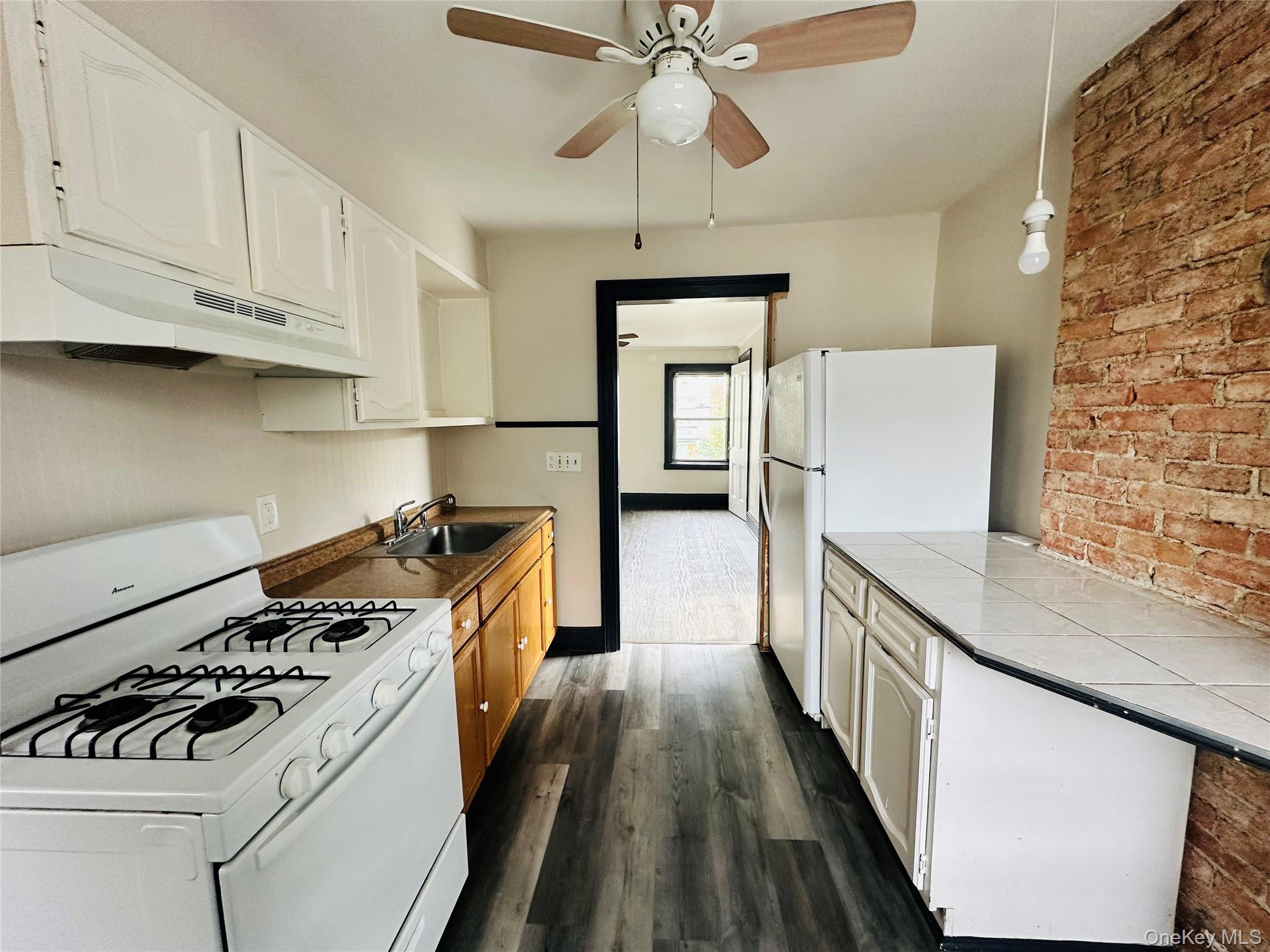 78 Garden Street, Unit B Poughkeepsie, NY 12601 - Photo 5 of 8 a kitchen with stainless steel appliances a stove a sink and a refrigerator