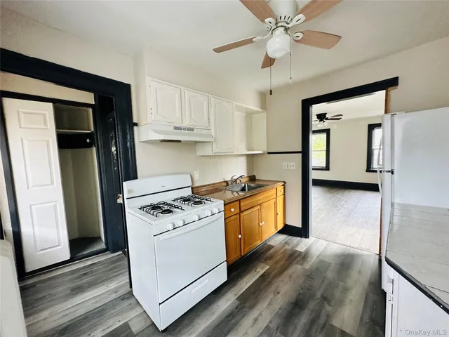 a kitchen with stainless steel appliances granite countertop a stove a refrigerator and a cabinets