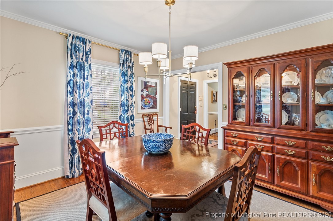 503 Rush Road Fayetteville, NC 28305 - Photo 17 of 50 a dining room with furniture a chandelier and window